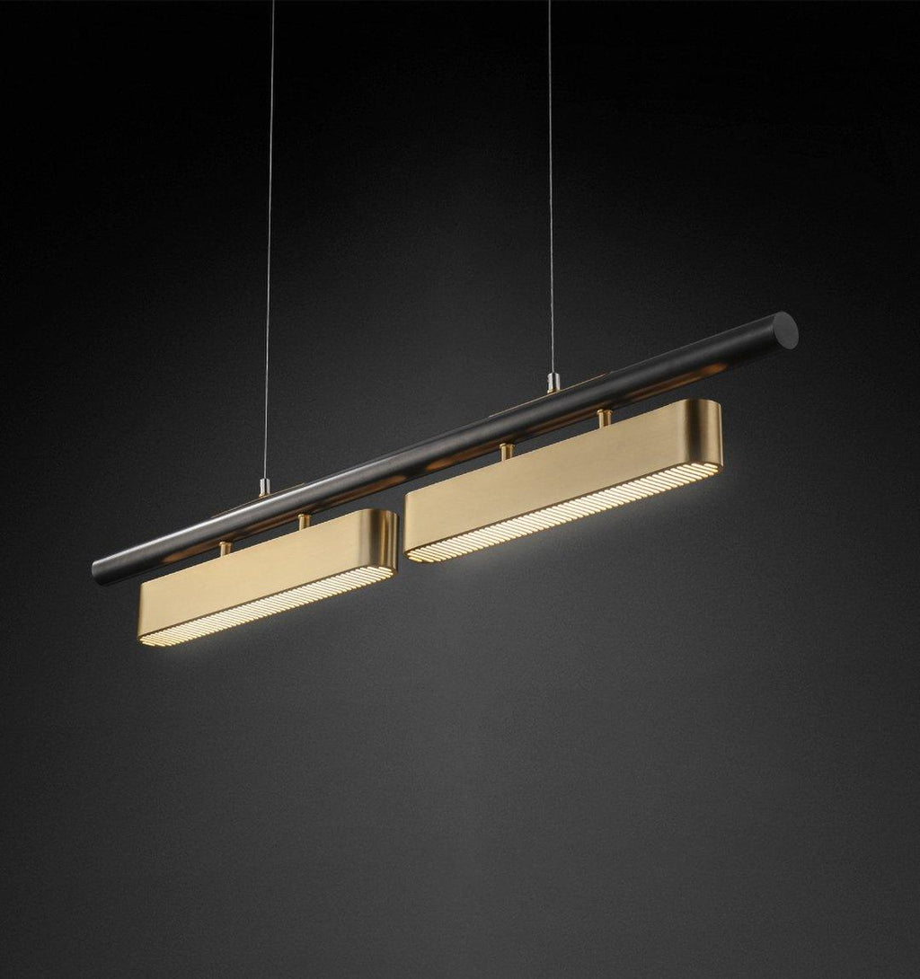 Clérachic linear pendant with two brass diffusers on a black bar, hung on thin wires and angled against a near-black backdrop.