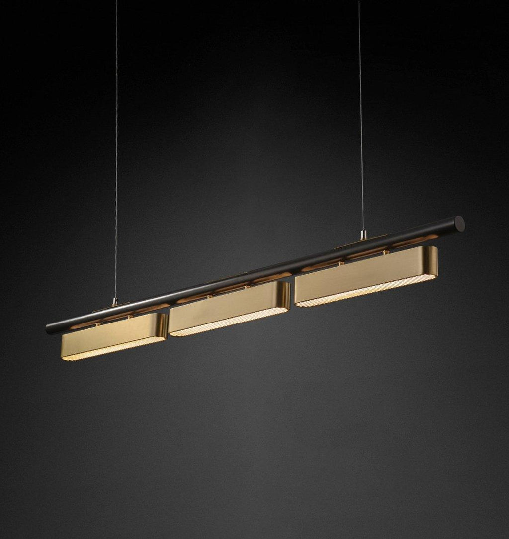 Three-head Clérachic linear pendant in brass and black, angled in front of a dark backdrop with the lit panels facing down.