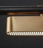 Close view of a brass diffuser on this Clérachic pendant, showing the row of narrow lit slots along its lower edge.