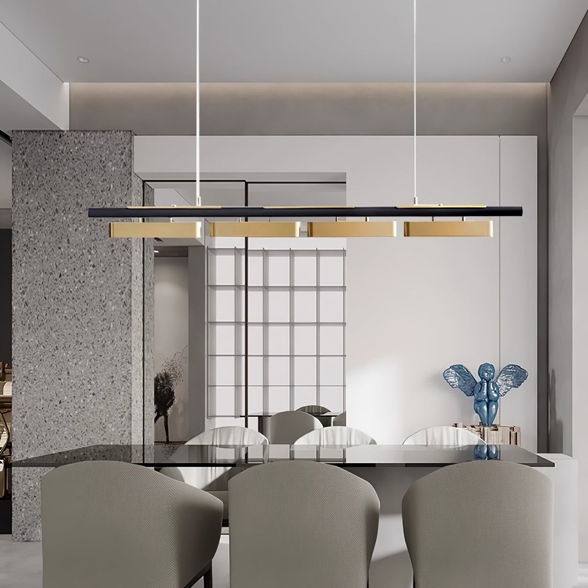A four-head Clérachic linear pendant over a dining table in a light room with a grey stone wall and a grid-pane window.