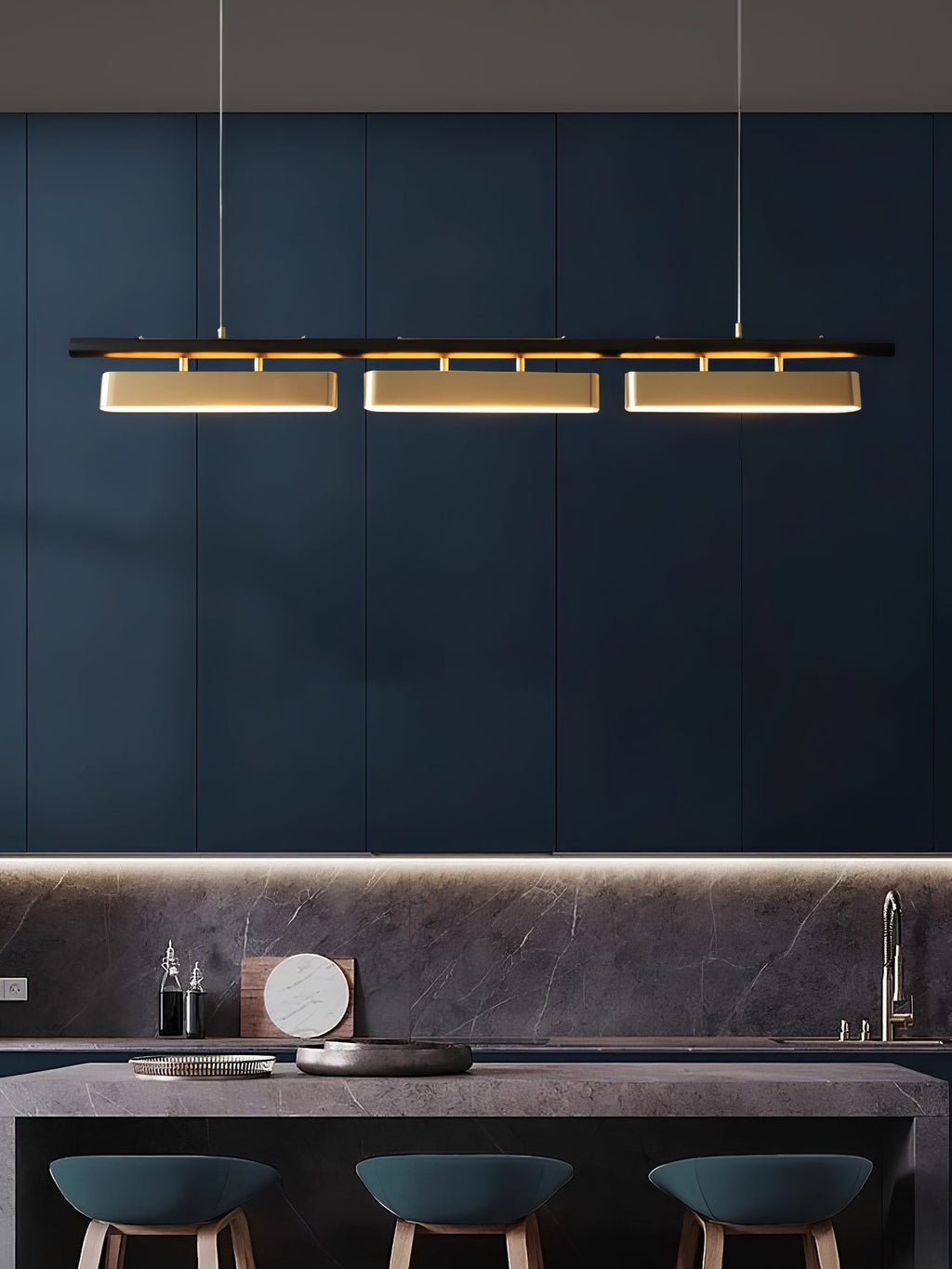 Three-head Clérachic pendant on a deep blue wall above a bar counter with teal stools and a dark splashback.