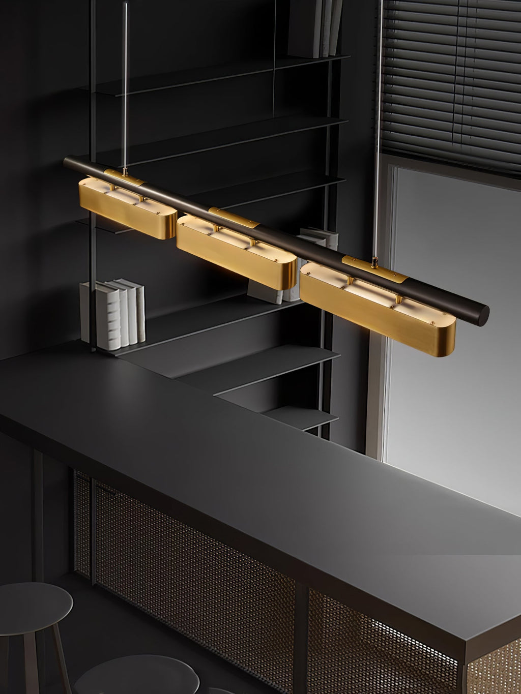 A Clérachic linear pendant with brass heads at an angle over a black bar counter, with a shelf of white books behind.