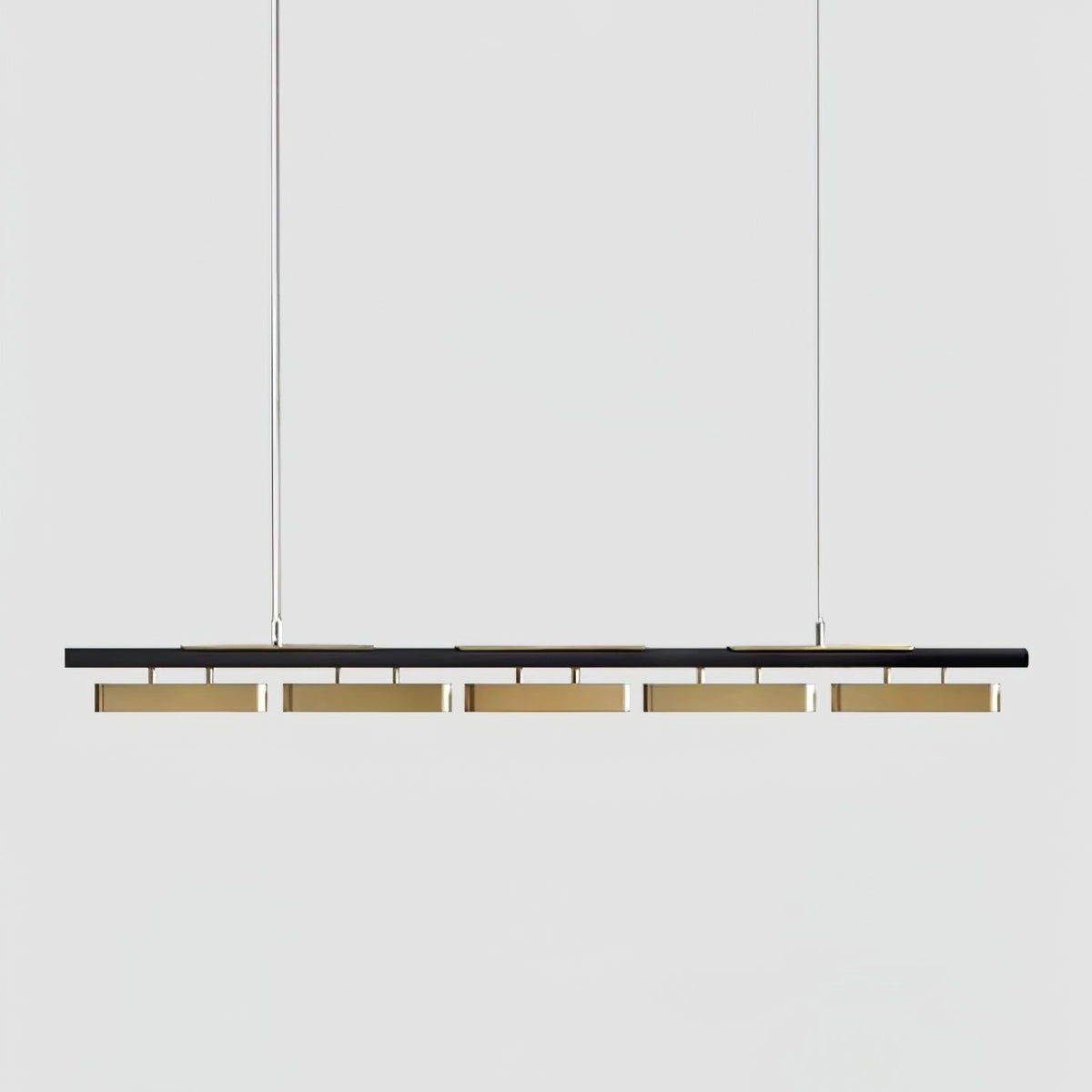 A five-head Clérachic linear pendant on a light grey backdrop, with a slim black bar and brass diffusers hung on two wires.