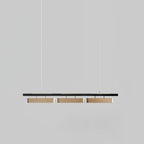 Three-head Clérachic linear pendant against a mid-grey backdrop, with brass diffusers and two thin suspension wires.