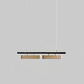 Two-head Clérachic linear pendant on a grey backdrop, with two longer brass diffusers beneath the black bar.