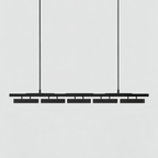 A five-head Clérachic linear pendant in all black, hung on two stiff rods against a pale grey backdrop.