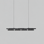 All-black Clérachic linear pendant with four heads, hung on thin wires against a light grey backdrop.