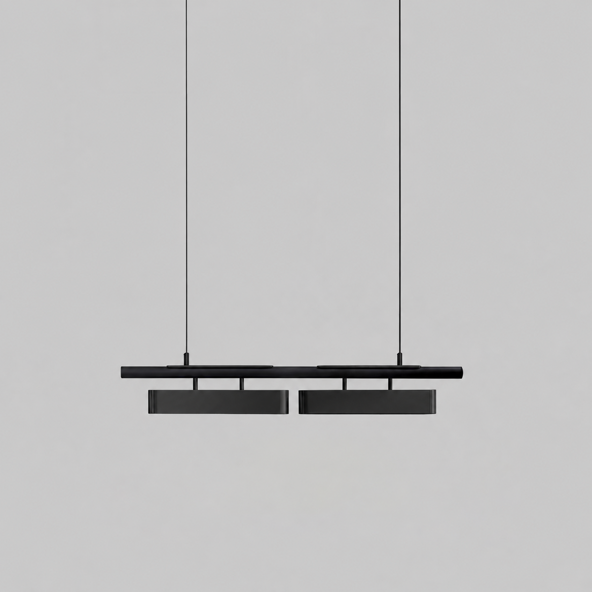 All-black two-head Clérachic linear pendant with larger diffusers, hung against a pale grey backdrop.