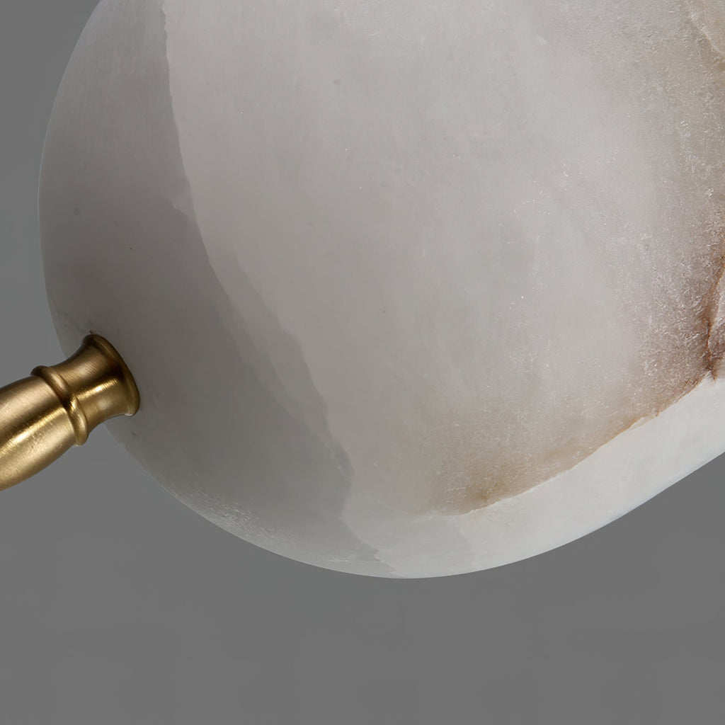Brushed brass cuff meeting veined Spanish alabaster on the Clérachic Brass Pendant Light, tan mottling on the stone.