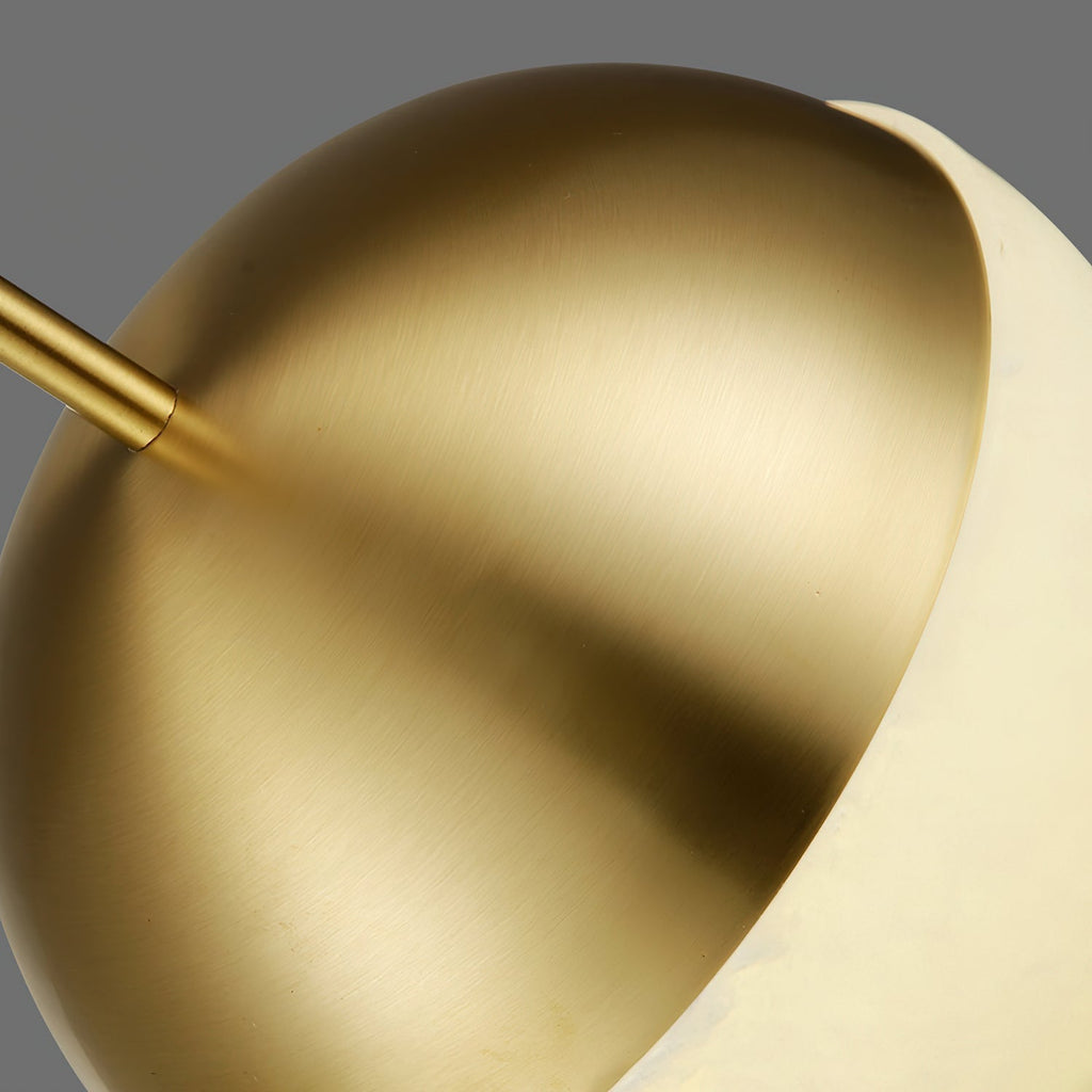 Close crop of the Clérachic Brass Pendant Light: brushed brass dome meeting the cream Spanish alabaster at a clean seam.