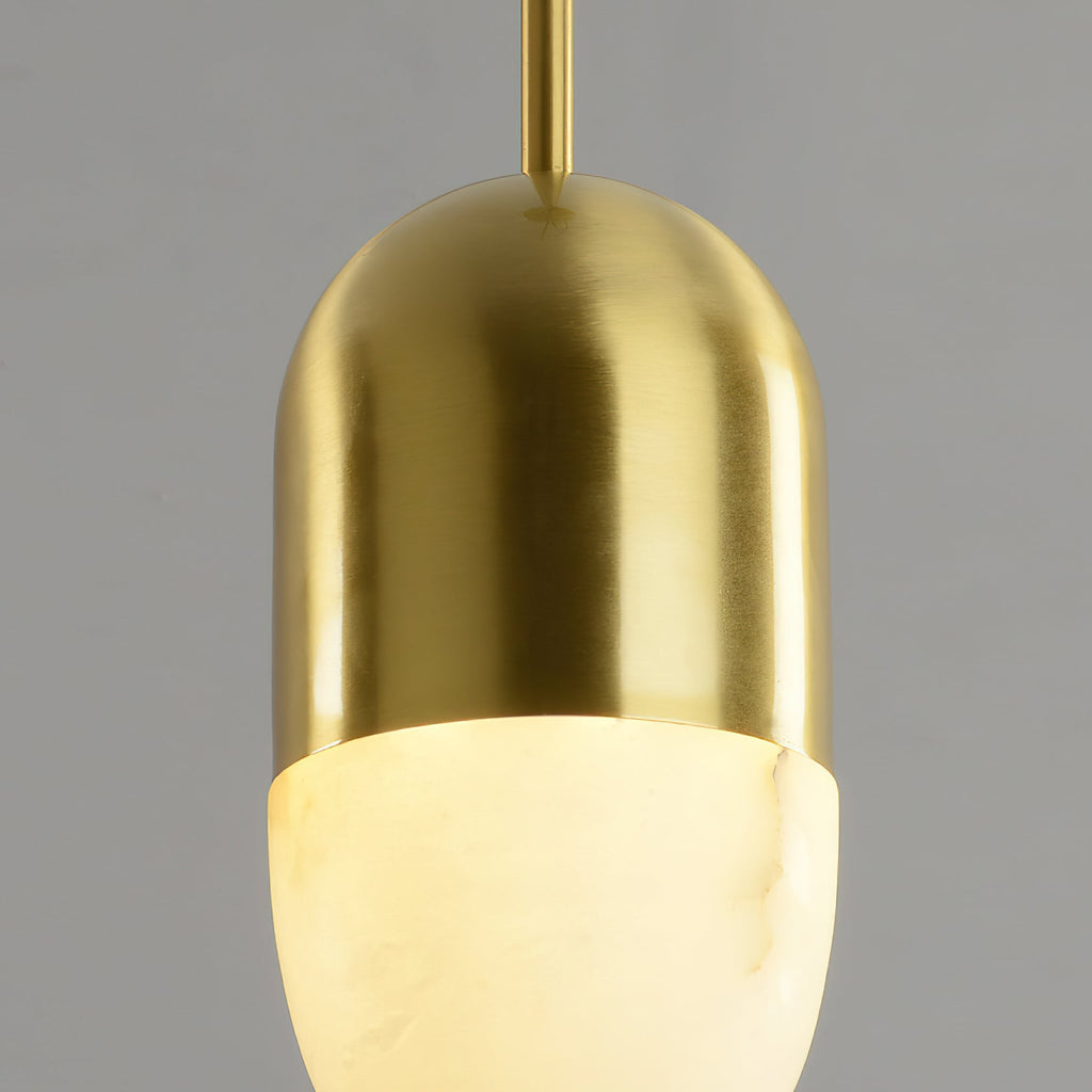 Clérachic Brass Pendant Light close-up: glowing Spanish alabaster meeting the vertically brushed brass dome.