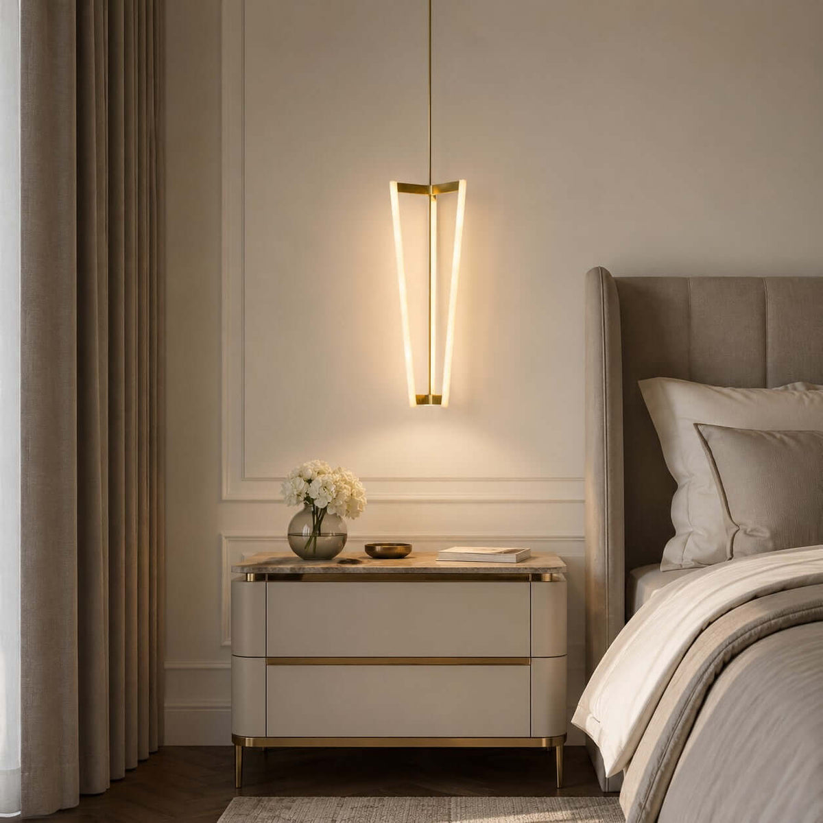 Hung beside a bed and a cream bedside chest, this Clérachic pendant lights a panelled bedroom wall with three slim glowing tubes.