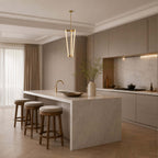 Above a marble-edged kitchen island with three stools, this Clérachic pendant hangs near the hob in a calm taupe kitchen.
