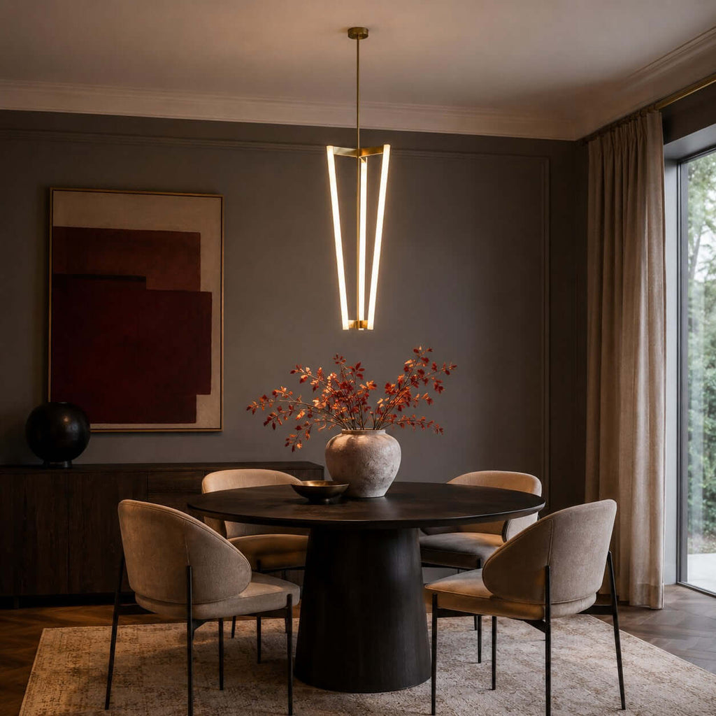 Over a round dark table with a vase of red autumn stems, this Clérachic pendant hangs against a dark wall and abstract print.