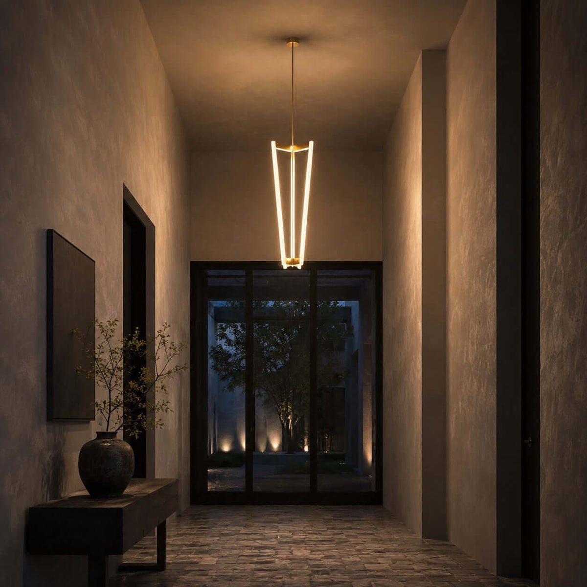 At the end of a dim stone-walled hallway, a Clérachic pendant hangs from a brass rod in front of a glazed door.