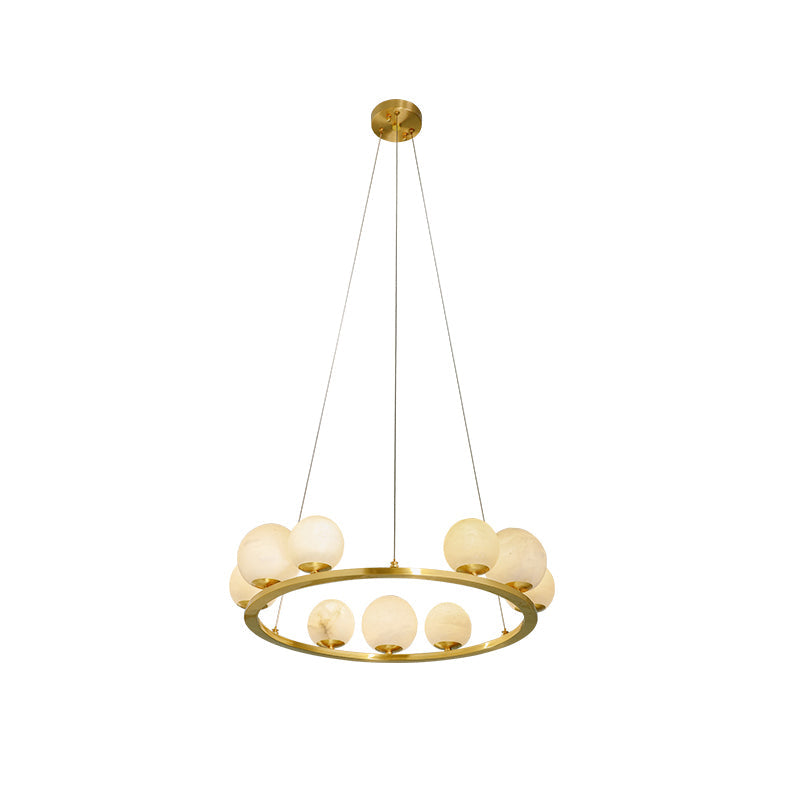 The Clérachic brass ring chandelier photographed on white, its nine alabaster globes split between the rim and the ring's inner edge.