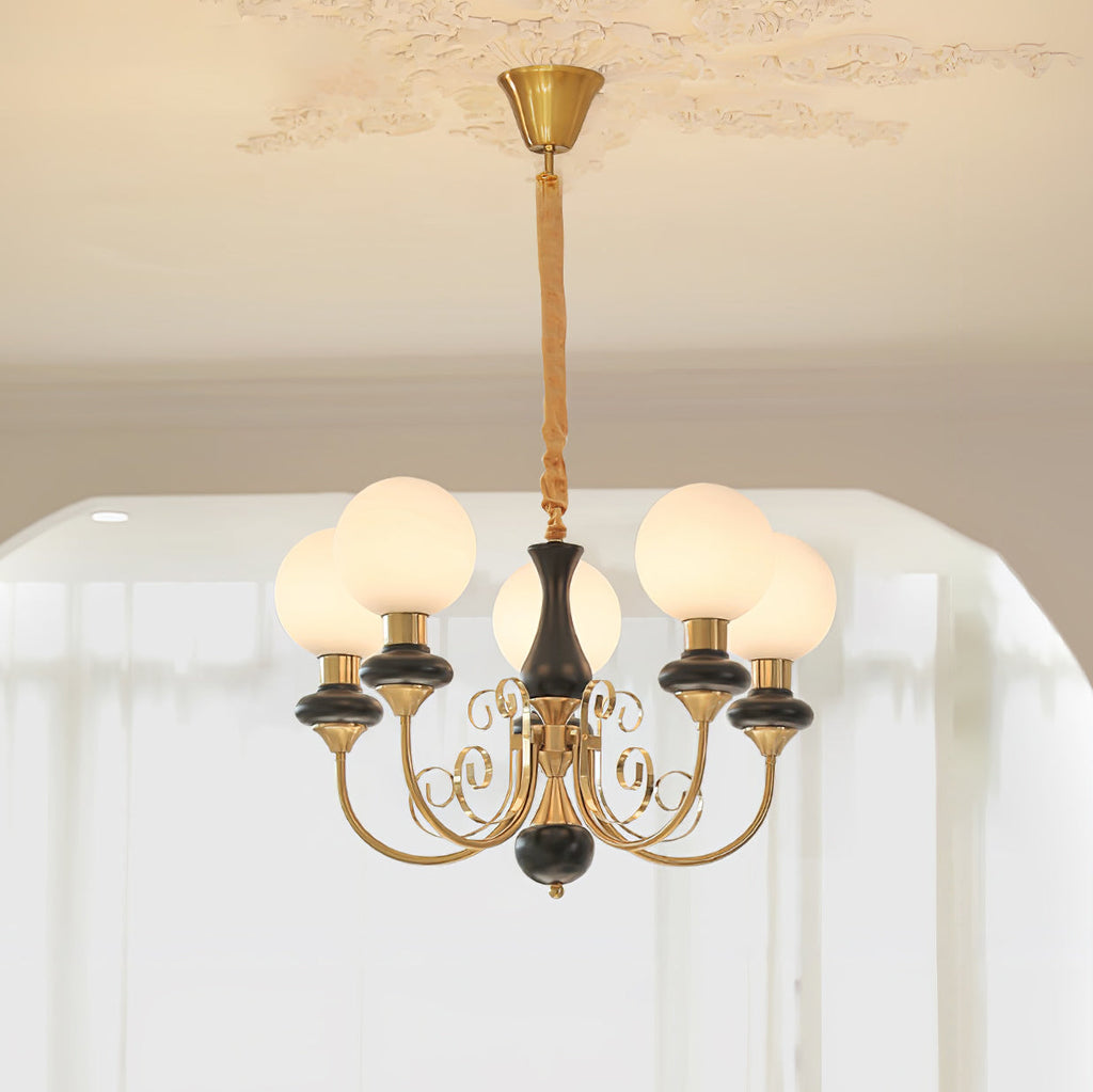Clérachic Brass Scrollwork Chandelier in black, five opal globes lit beneath a decorative plaster ceiling rose.