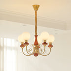Five-light Clérachic Brass Scrollwork Chandelier in red-brown, its opal globes spread wide under a bright corniced ceiling.