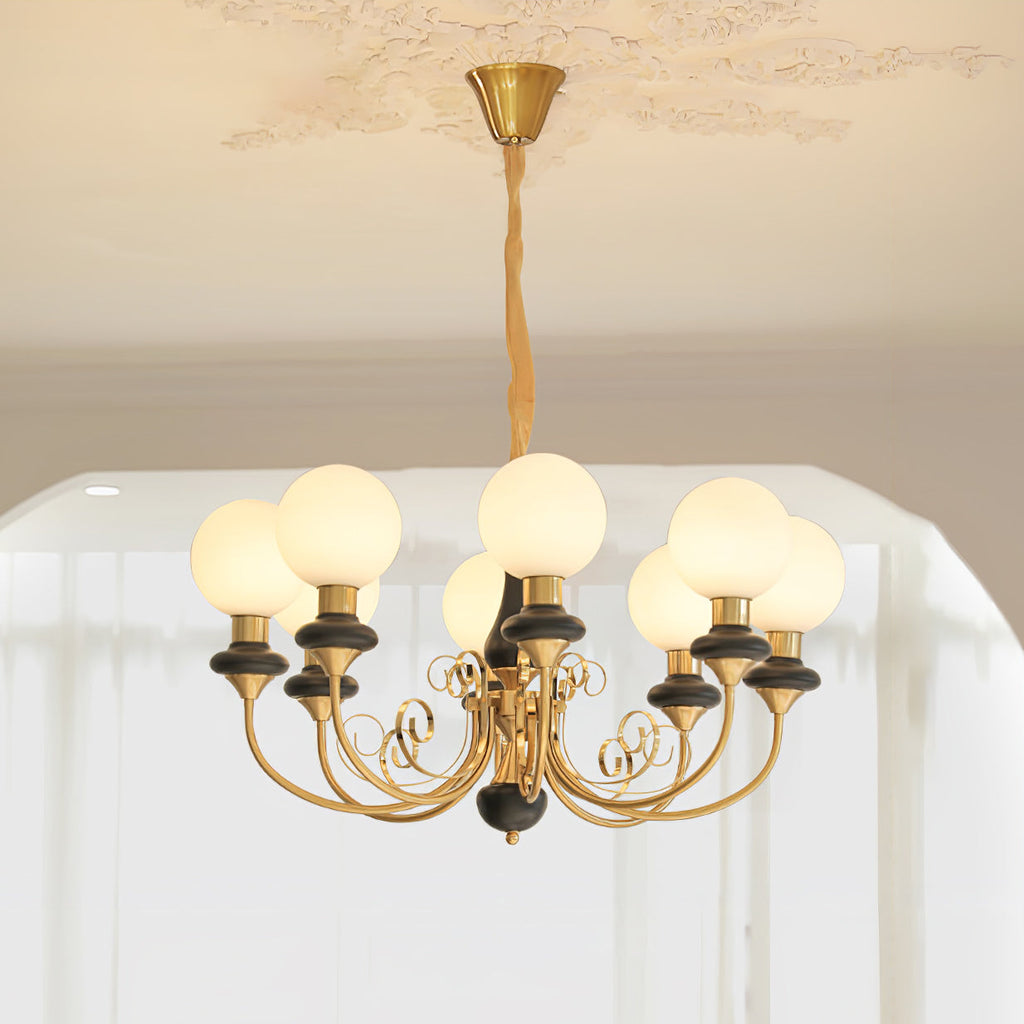 Clérachic Brass Scrollwork Chandelier in black, eight lit opal globes staggered around one ring of curved arms.
