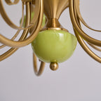 Underside of the Clérachic Brass Scrollwork Chandelier showing the green base cup and the small brass finial ball.