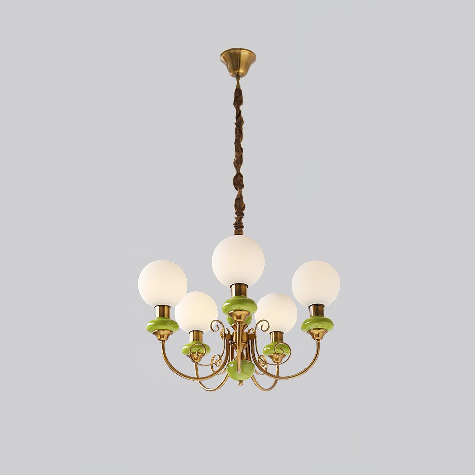 Green Clérachic Brass Scrollwork Chandelier at full drop on grey, brass canopy above five lit opal globes.
