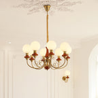 Red-brown Clérachic Brass Scrollwork Chandelier with eight lights, hung from a plaster rose beside a matching sconce.