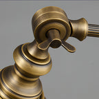 Close view of the brass pivot joint and wing screw that let the shade of this Clérachic lamp tilt, with a brushed finish.