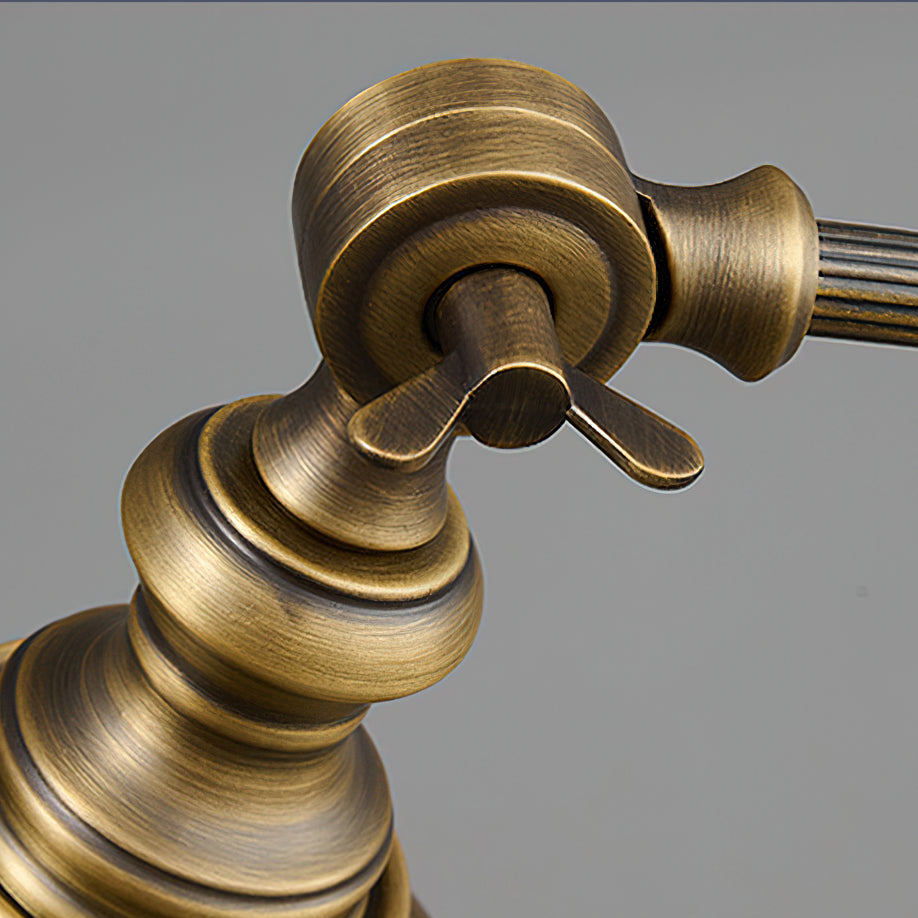 Close view of the brass pivot joint and wing screw that let the shade of this Clérachic lamp tilt, with a brushed finish.