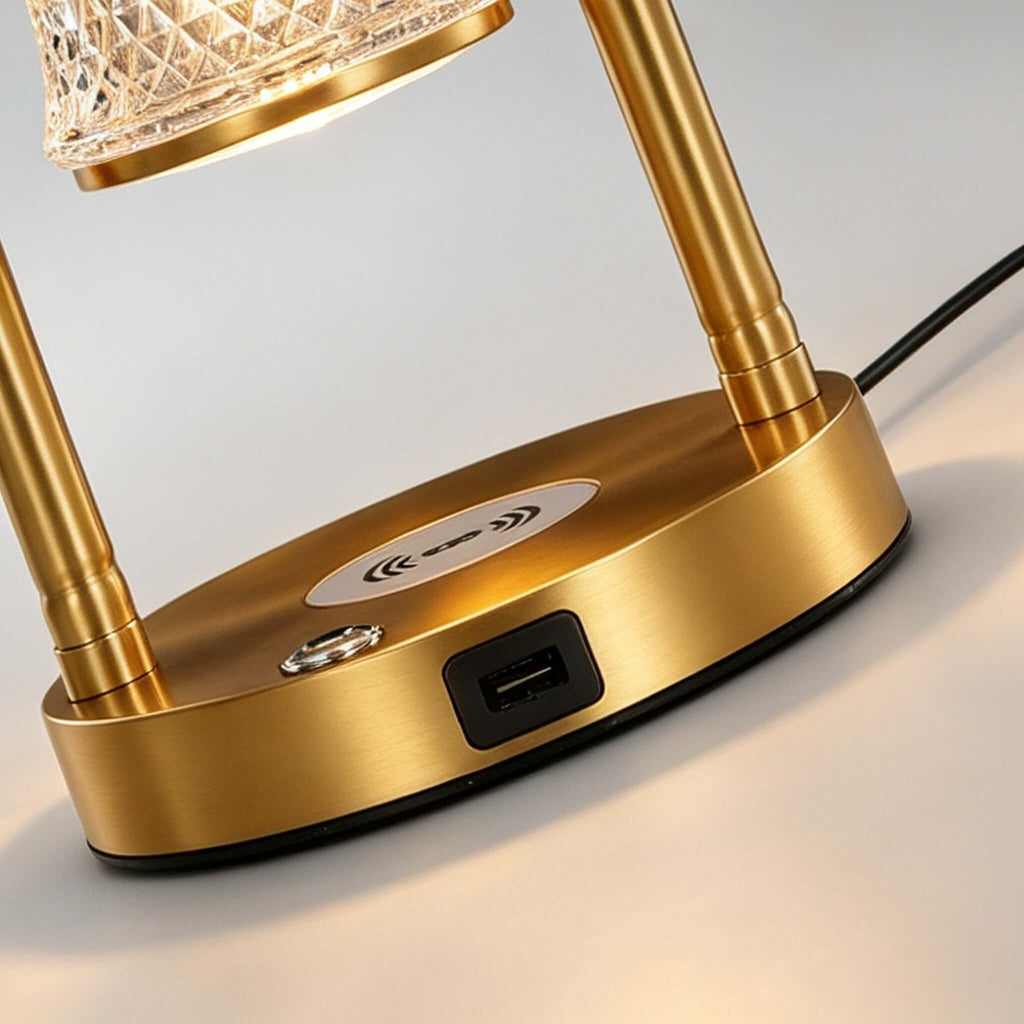 Close view of the brass base on this Clérachic table lamp, showing a round wireless charging pad, a switch and a USB port.