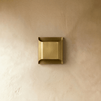 Clérachic antiqued brushed brass wall light switched off, a clean rectangular profile with softly curved top and bottom lips.