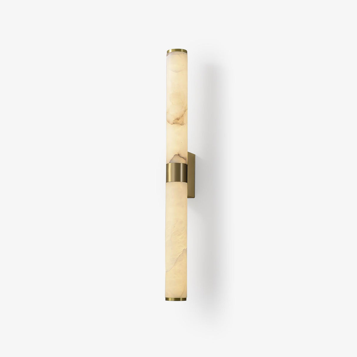 A tall alabaster tube wall light on a plain white backdrop, with a brass band at the middle and a small brass wall plate, from Clérachic.