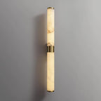 Close view of the veined alabaster of this Clérachic wall light, with its brass band and end caps against a grey wall.