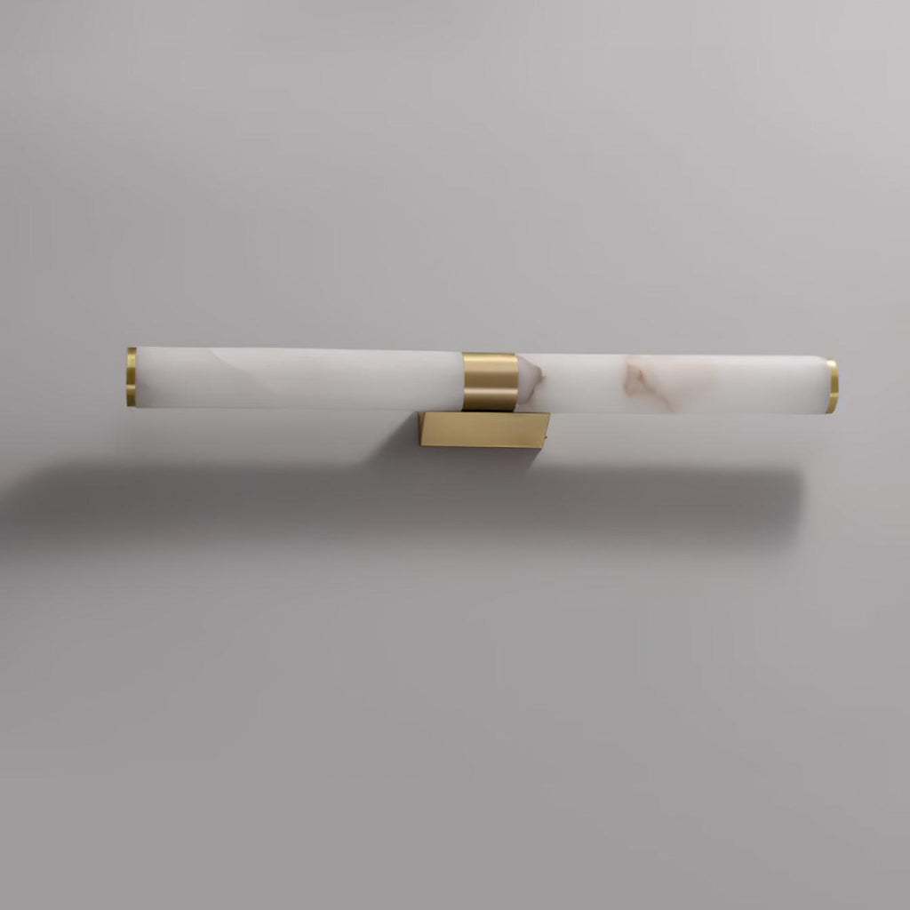 Mounted sideways, this Clérachic alabaster tube light with a brass band and a small wall plate sits on a pale grey wall.
