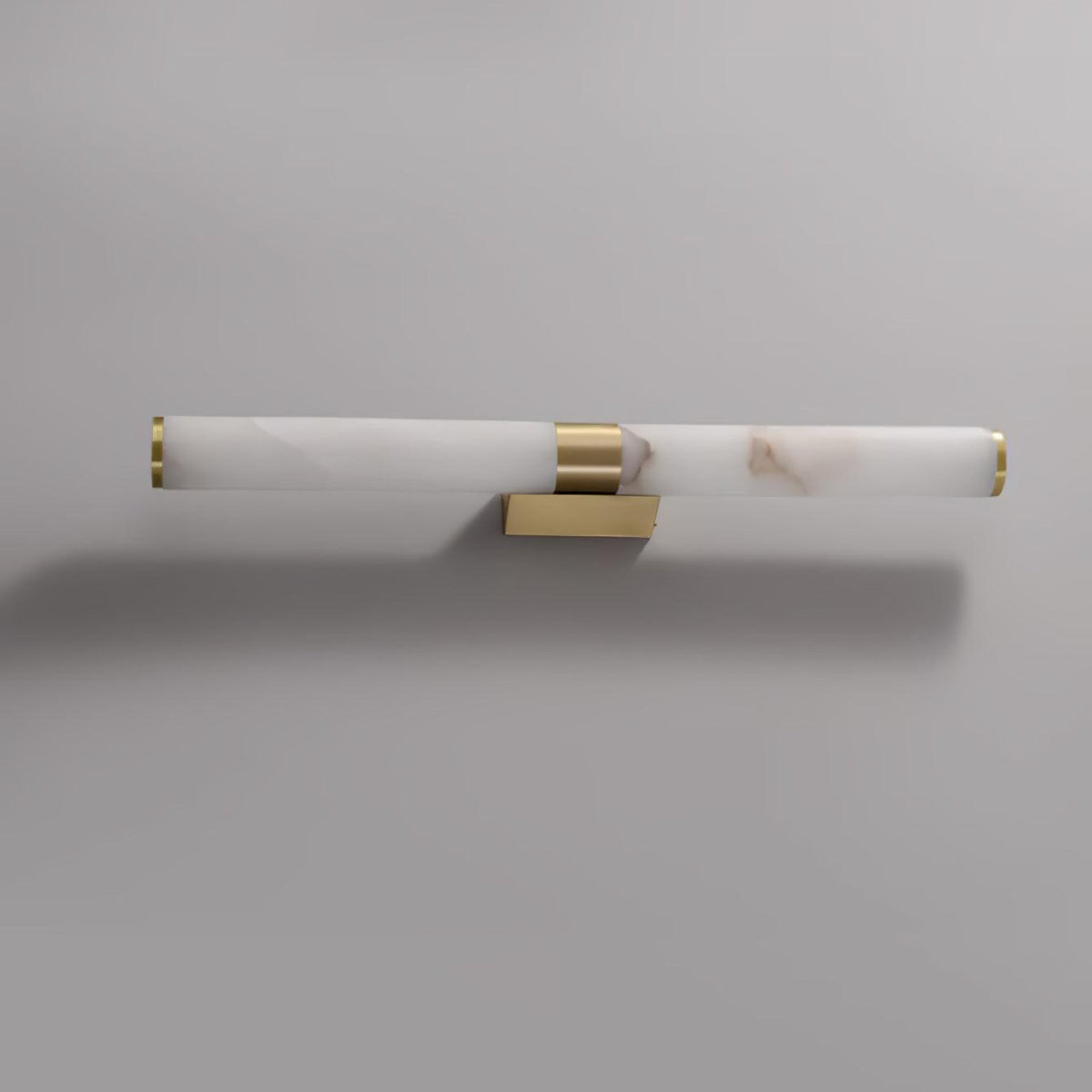 Mounted sideways, this Clérachic alabaster tube light with a brass band and a small wall plate sits on a pale grey wall.