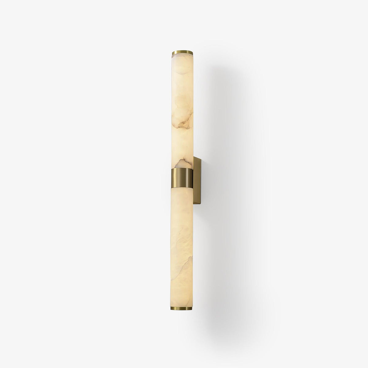 A veined alabaster tube wall light with a brass band and plate, on a soft white background with a faint shadow, from Clérachic.