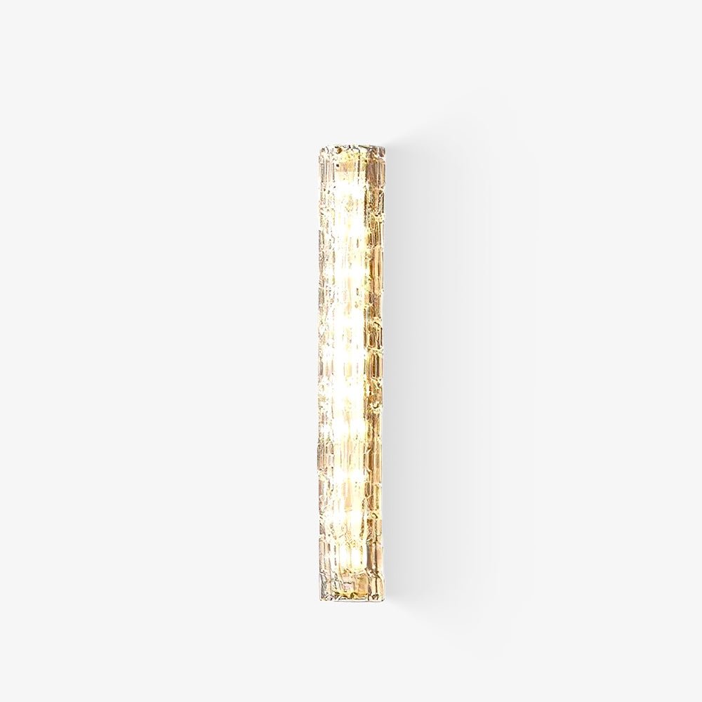 Tall slim wall light from Clérachic, a gold frame behind a clear textured glass shade with glowing LEDs, on a plain white backdrop.