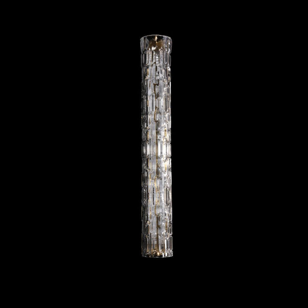 Switched-off Clérachic wall light on black, a longer model with a clear faceted glass cylinder and gold fittings.