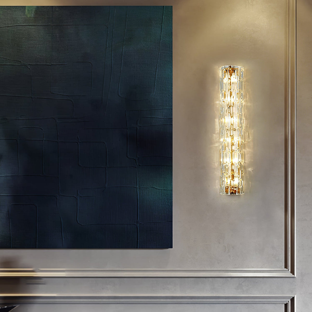 Clérachic wall light lit beside a large dark blue textured canvas on a grey panelled wall.