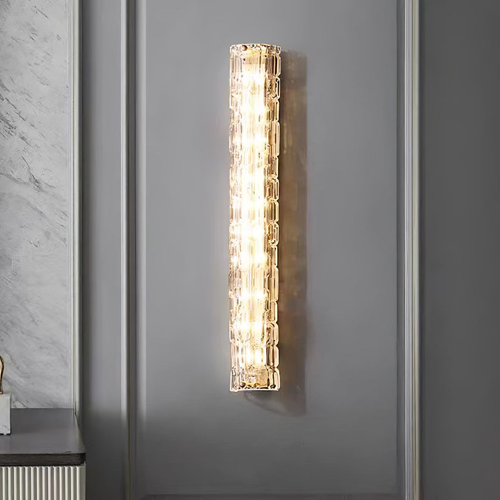 Large view of a Clérachic wall light lit against a grey panelled wall, with a marble-effect wall at the left.