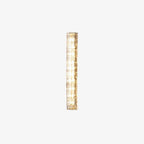 Small view of a Clérachic wall light on a white backdrop, its clear glass shade and gold frame lit from inside.