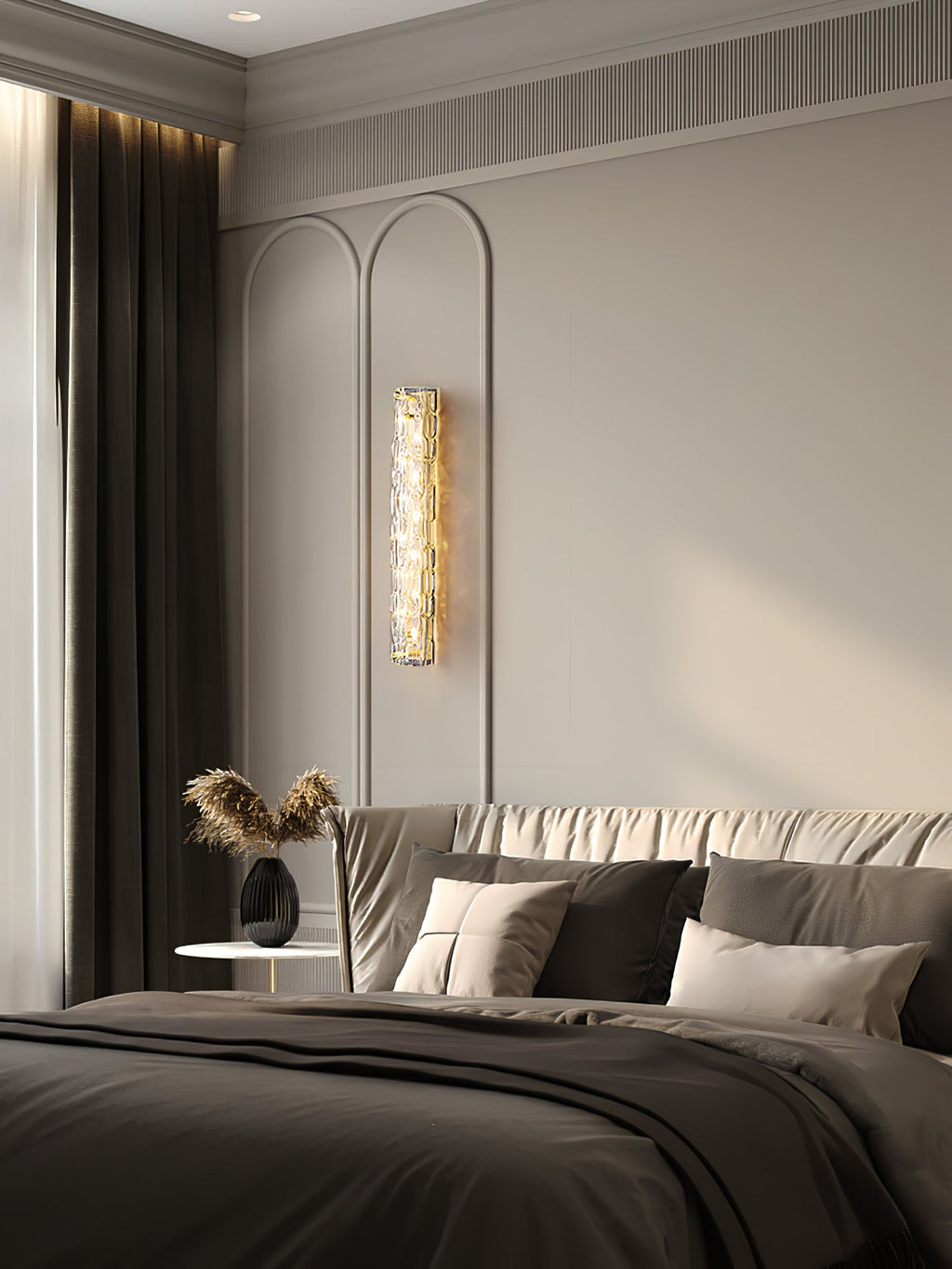 A Clérachic glass wall light lit between arched wall panels in a bedroom, with a dark curtain and a bed in grey linen.