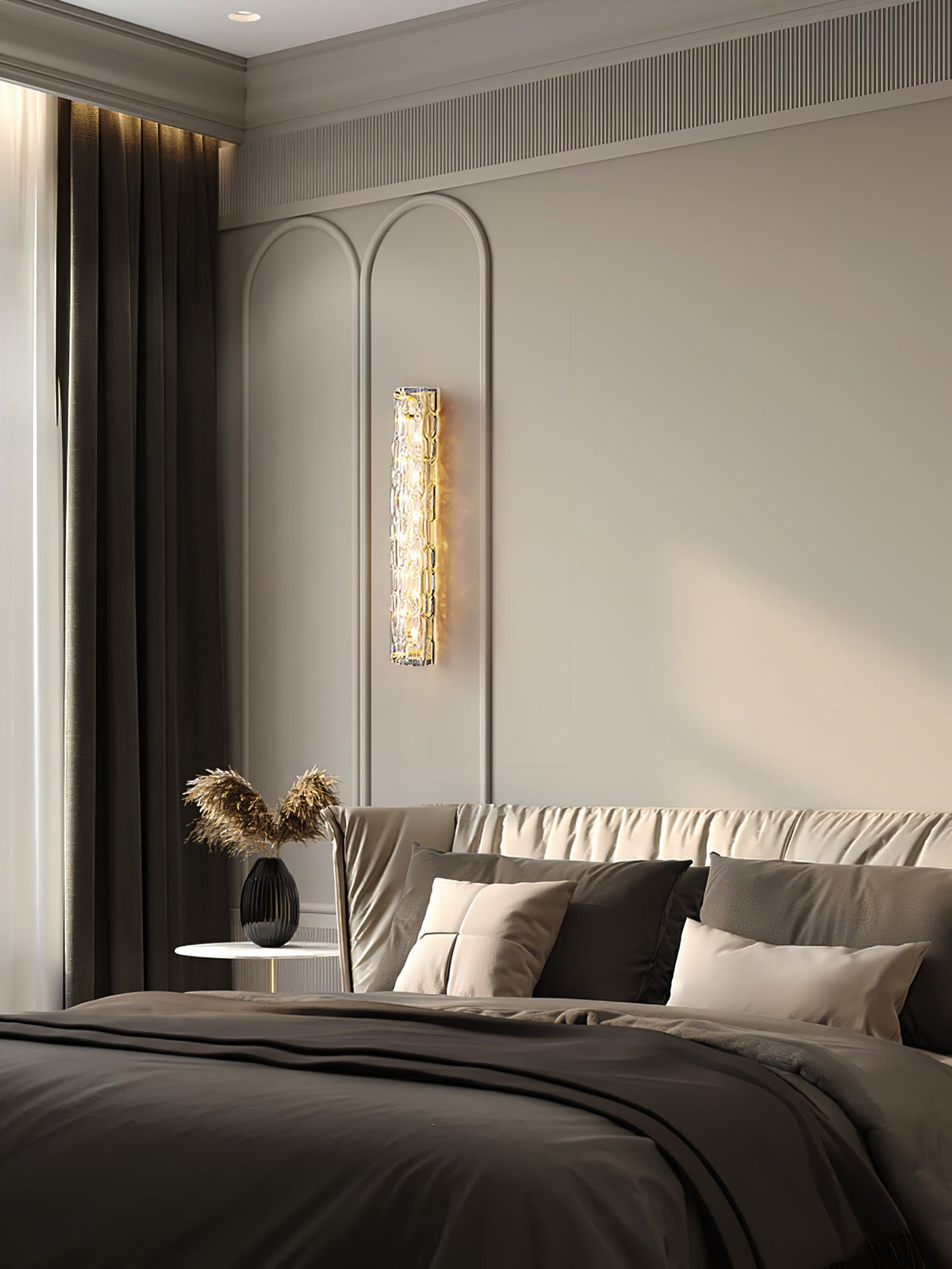 A Clérachic glass wall light lit between arched wall panels in a bedroom, with a dark curtain and a bed in grey linen.