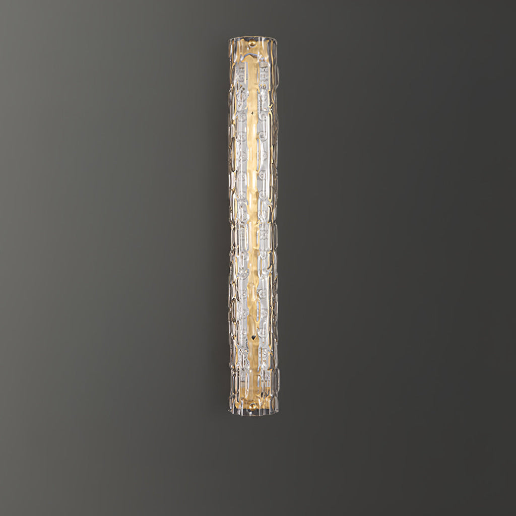 A Clérachic wall light with clear glass and a gold backplate, shown on a dark grey wall.