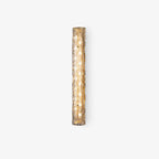 Unlit Clérachic wall light on a pale grey backdrop, with its rippled glass and gold backplate visible.