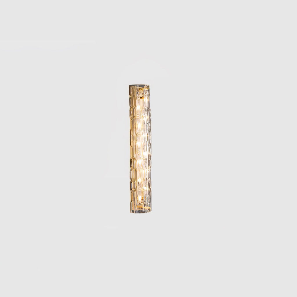 Small Clérachic glass wall light lit on a pale grey backdrop, its LEDs glowing behind the clear shade.
