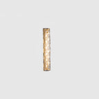 Small Clérachic glass wall light lit on a pale grey backdrop, its LEDs glowing behind the clear shade.