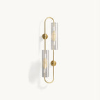 Brass wall light from Clérachic with two ribbed clear glass tubes on an elongated looped frame, unlit on a plain white backdrop.