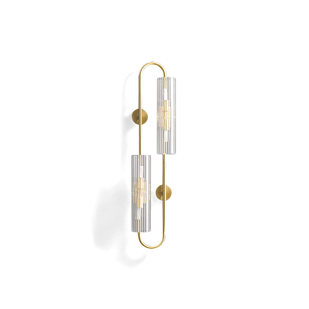 Cut-out view of this Clérachic brass wall light, its two ribbed glass tubes set on a long looped brass frame, on white.