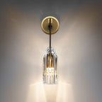 A lit Clérachic wall light on a dark, softly glowing wall, the clear crystal shade throwing bright streaks of light downward.