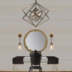 A pair of these Clérachic wall lights either side of a round gold-edged mirror above a black dressing table, under a geometric cage pendant.